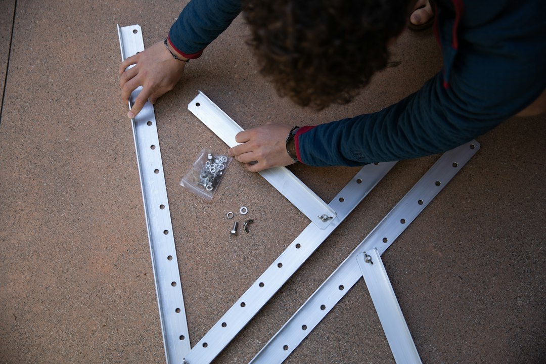 professional installing a reinforced garage door track - hurricane impact garage doors