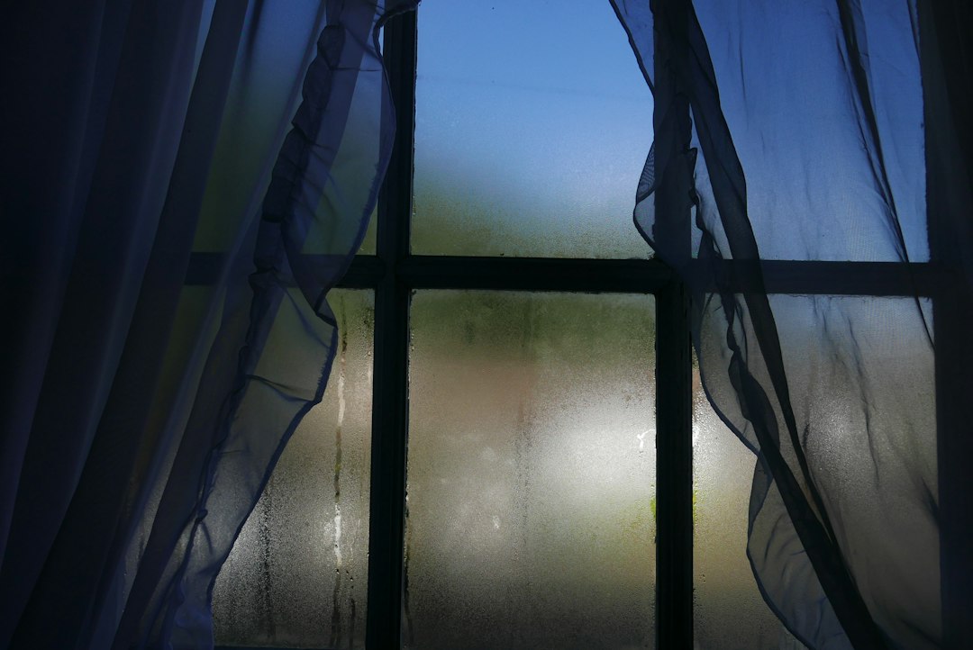 Image of a foggy window pane with condensation between the glass - local window installers near me