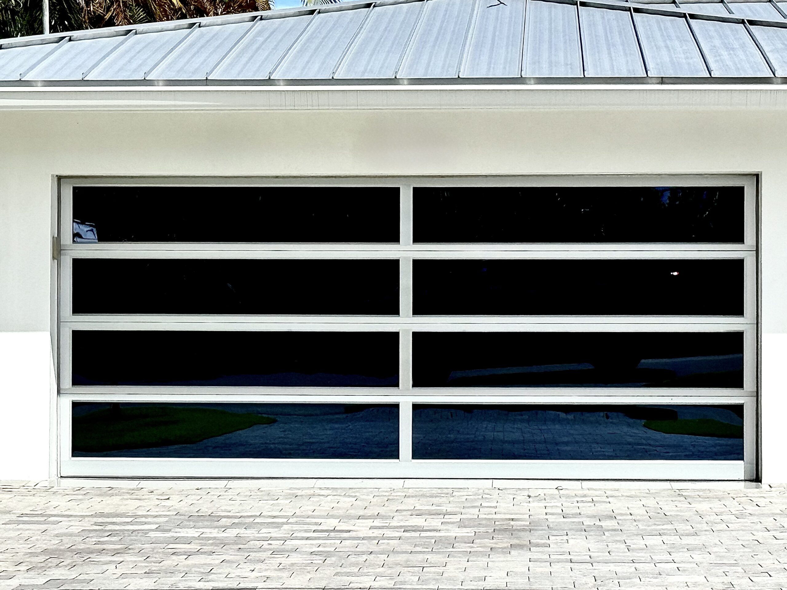 Custom glass garage door installation by Access Impact