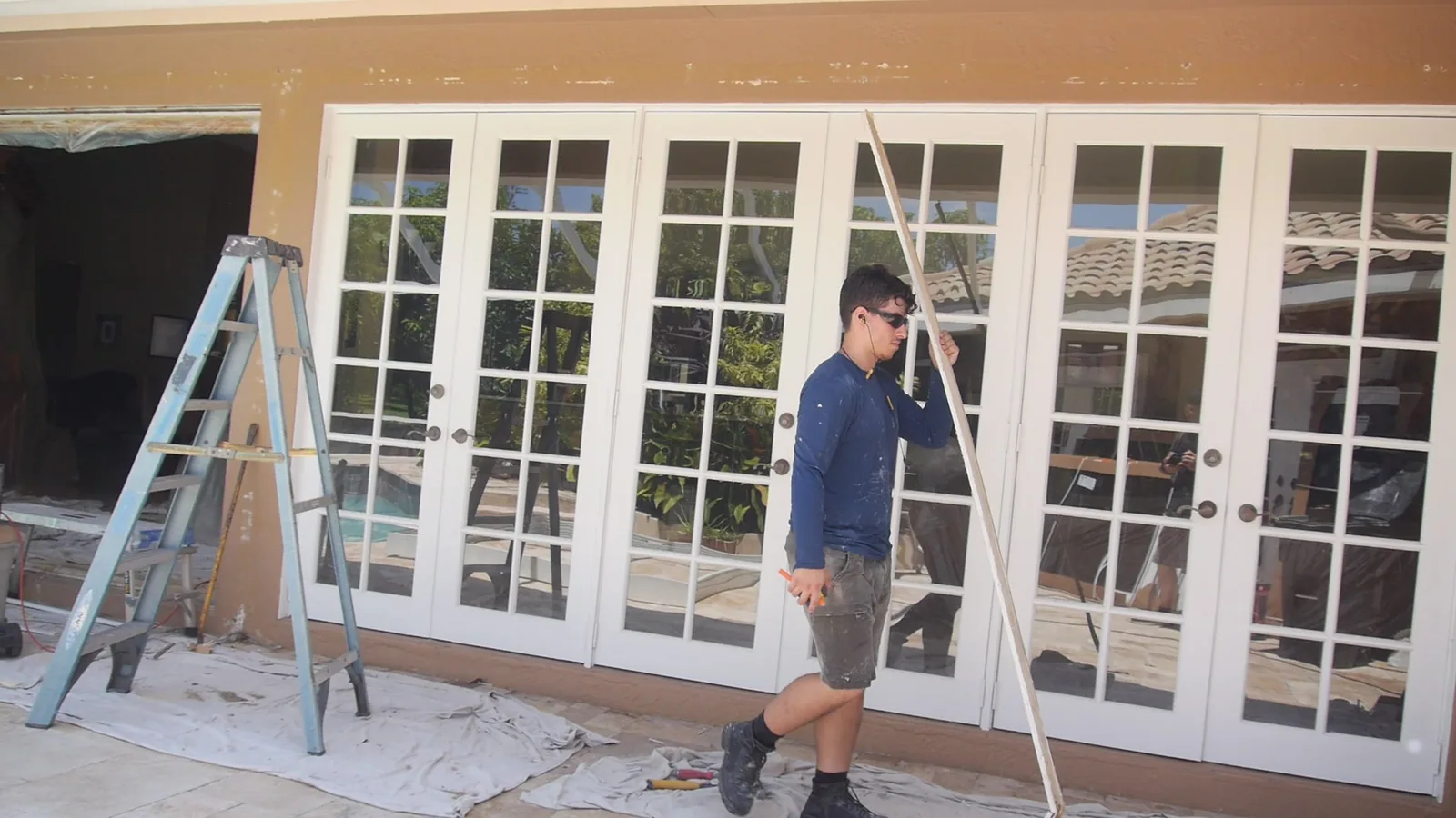 Crew installing impact French doors