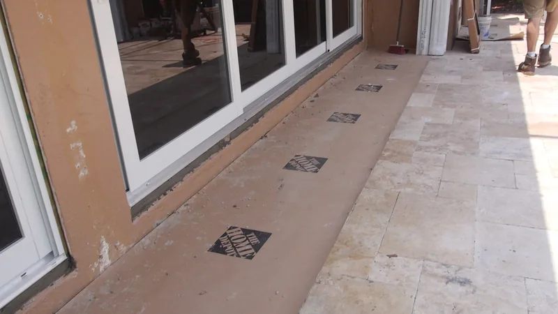 New sliding glass panels set along a tiled patio
