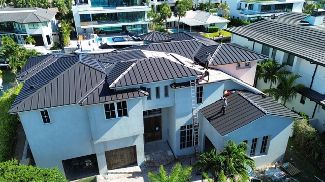 Modern metal roof on a waterfront home by Access Impact