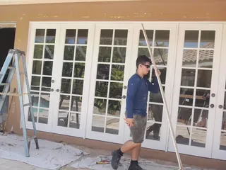 Our installer beside a wall of new French doors