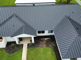 Charcoal standing-seam metal roof from above