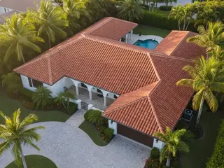 Finished terracotta tile roof on a home with a pool