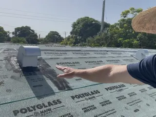 Our roofer pointing to new underlayment on a roof deck